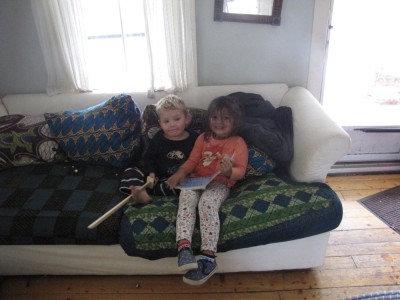 Lijah and Kamilah reading on the couch