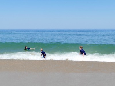 Harvey and Zion preparing to ride a moderate-sized wave