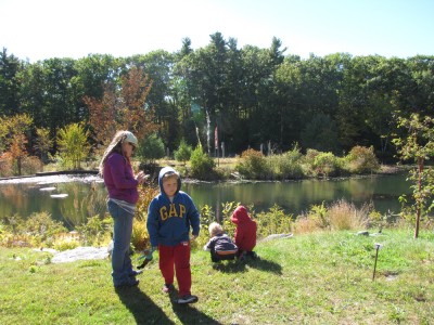 the family checking out art on the banks of the Old Frog Pond