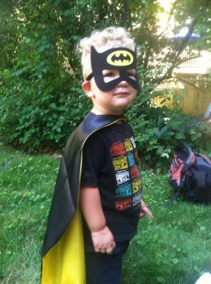 Lijah in a Batman cape and mask