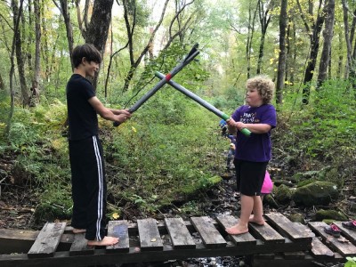 Harvey swordfighting Sam on a little bridge