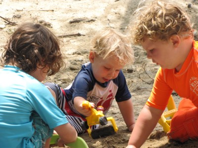 Harvey, Zion, and Hendrick digging in the sand at Walden Pond