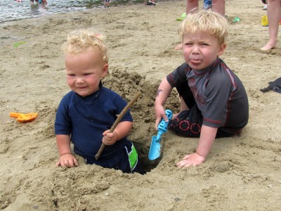 Zion and Lijah and the hole we dug; Zion spitting out sand