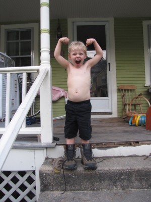 Zion making a muscle pose wearing my hiking boots