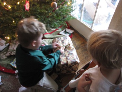 Harvey opening a present, Zion watching