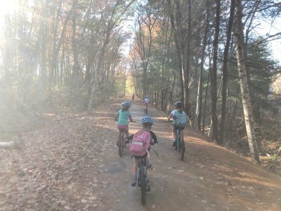 kids riding on a dirt bike path