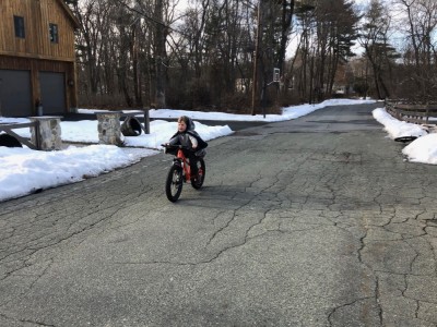 Elijah riding his new bike on our street