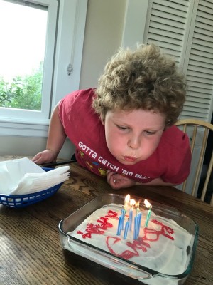 Harvey blowing out the candles on a birthday cake