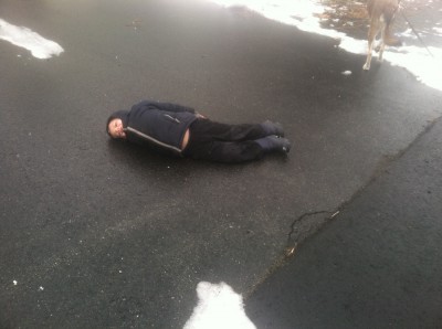 Zion lying on the ground on the black ice