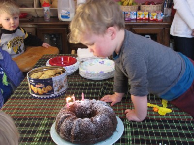 Lijah blowing out the second of his three candles