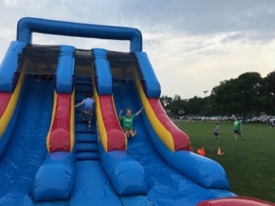 Zion zipping down an enormous inflatable slide