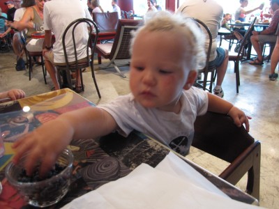 Lijah reaching for blueberries at the cafe