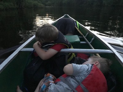 the kids lying down in the canoe