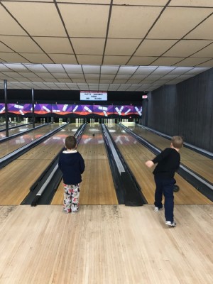 Lijah and Zion bowling in adjacent lanes