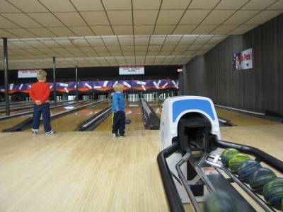 Harvey and Zion bowling on neighboring lanes