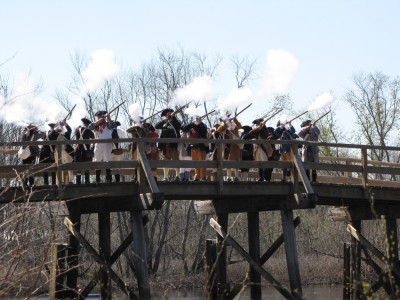 Sudbury Minutemen firing a volley from the Concord Bridge