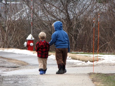 Zion and Harvey walking down the sidewalk together