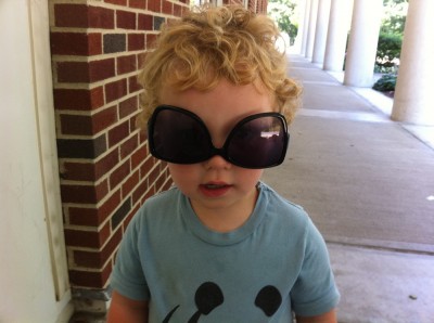 Harvey wearing Mama's sunglasses upsidedown