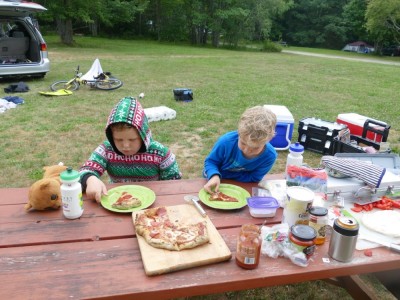 Harvey and Zion at a picnic table eating pizza
