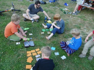 Tim and the boys playing Pokemon on the grass