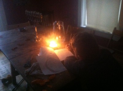 Harvey doing homework by candlelight