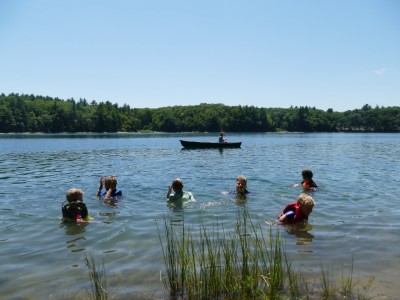 the boys and friends swimming in Walden pond, with the canoe