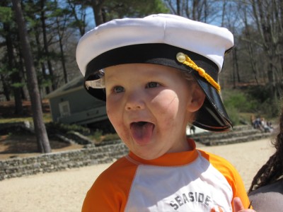 Lijah at the beach with Harvey's captain hat on