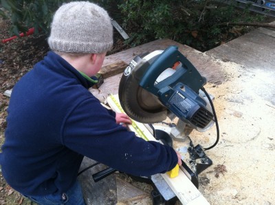 Harvey measuring a two-by-three on the chop saw