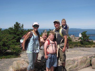 the Archibalds posing at the signpost atop Champlain Mtn