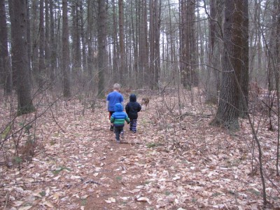 the boys walking in the woods with Rascal wearing warm clothes