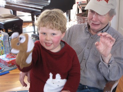 Harvey on Grandpa's lap with a puppet