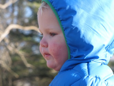 Lijah's face in profile, bundled in the hood of his down coat