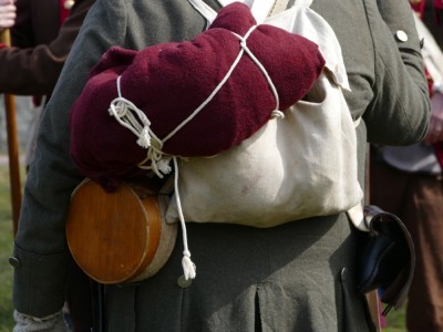 a backpack, bedroll, and canteen on the back of a reenactor