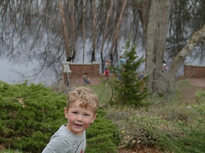 Lijah up high above the Concord River; other kids on a pavilion nearer the water