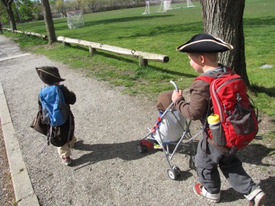 the boys walking along a path, in pirate (and monkey) costumes
