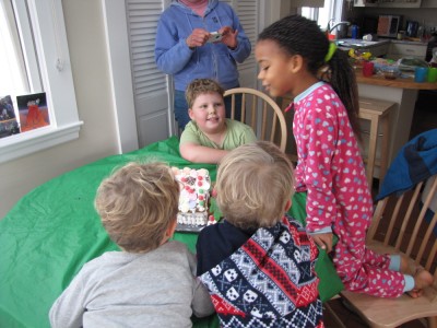 the boys and Nisia getting ready to share a gingerbread house