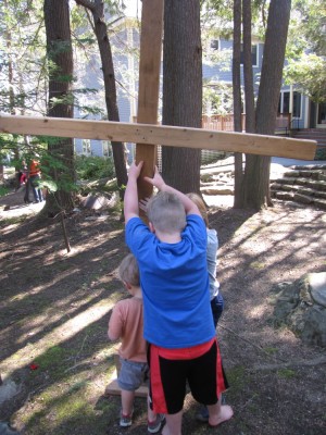 Harvey, Zion, and Nathan putting up a wooden cross