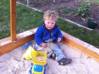 Harvey in the sandbox covered with sand