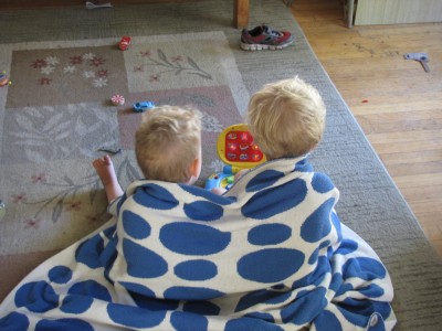 Zion and Lijah sharing a blanket