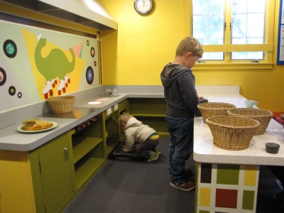 Lijah and Harvey working in the life-sized play kitchen