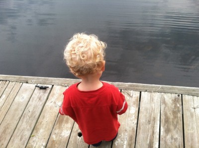 Lijah standing on a dock looking at the water