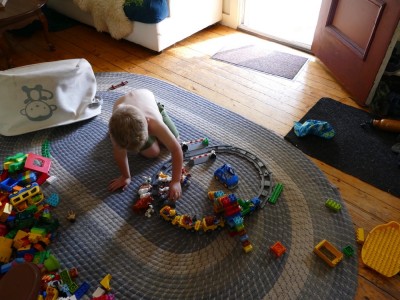 Zion playing with duplo train tracks
