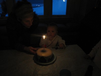 Elijah in the dark looking at his lit birthday candle