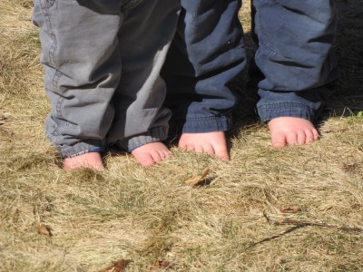 Zion's and Harvey's bare feet in the yellow winter grass