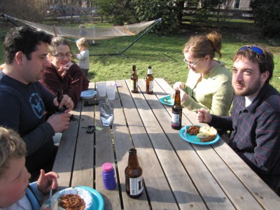 a few friends eating at the picnic table outside