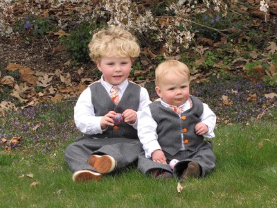 Harvey and Zion posing in their Easter suits below the flower tree