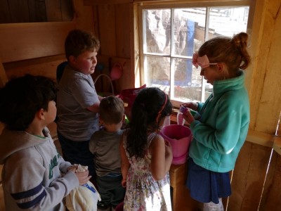 kids trading egg prizes in the playhouse