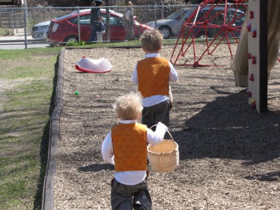 Harvey and Zion running to find eggs in the church playground