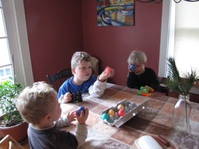 the boys at the kitchen table with dyed hard-boiled eggs and binoculars (?)