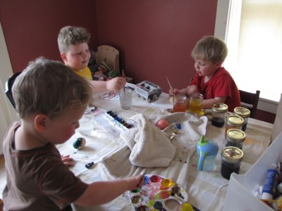 the boys decorating eggs at the kitchen table